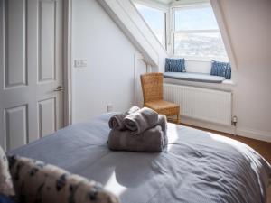 a bedroom with a bed with a towel on it at The Wheelhouse in Fowey