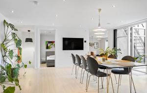 a dining room and living room with a table and chairs at Nice Apartment In Randers C With Wifi in Randers