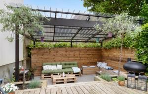 a patio with a couch and a pergola at Nice Apartment In Randers C With Wifi in Randers +10 photos