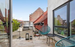 a balcony with two chairs and a window at Nice Apartment In Randers C With Wifi in Randers