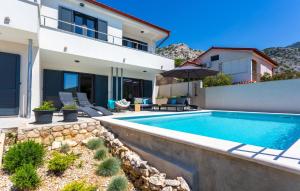 a swimming pool in front of a house at Awesome Home In Lukovo With Sauna in Lukovo