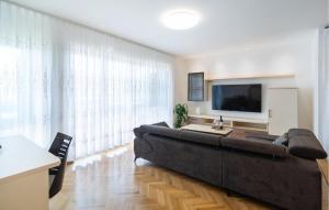 a living room with a large couch and a flat screen tv at Apartment Pojlicka Cesta Iv in Krilo