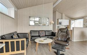a living room with leather furniture and a table at Holiday Home Sønderballevej Rødekro I in Diernæs