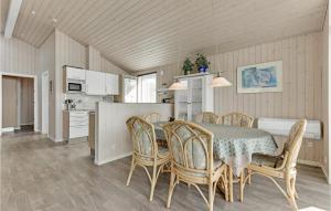 a kitchen and dining room with a table and chairs at Holiday Home Sønderballevej Rødekro I in Diernæs