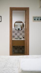 a bedroom with a door with a mirror on the wall at Dimora del Pescatore - Holiday House in Cefalù