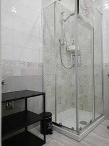 a shower with a glass door in a bathroom at LA CASA DEL RIONE SANITA’ in Naples