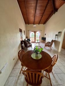 a dining room with a wooden table and chairs at Caribbean Breeze in Gros Islet