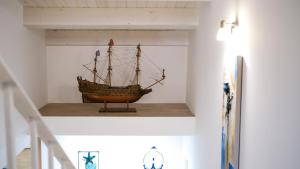 a wooden ship on a shelf in a room at Dimora del Pescatore - Holiday House in Cefalù