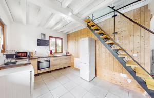 een keuken met een trap in het midden van een kamer bij Lovely Home In Malleville-les-grs With Wifi in Malleville-les-Grès