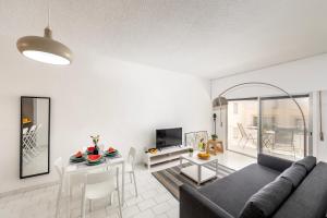 a living room with a couch and a table at Protaras O2 Seaside Suite in Protaras
