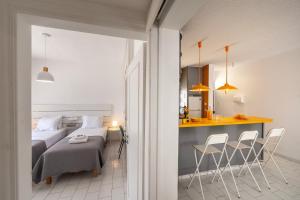 a bedroom with a bed and a table and chairs at Protaras O2 Seaside Suite in Protaras