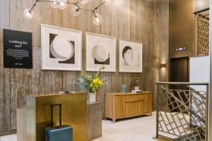 a lobby with three pictures on the wall and a suitcase at Sonder The Arts Council in London