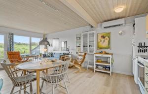 a kitchen and dining room with a table and chairs at Lejl, 1 in Havrvig