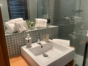a bathroom with a white sink and a shower at Garibaldi in Trapani