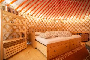 a bedroom with a bed in a yurt at Jurta pod Kriváňom in Vavrišovo