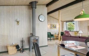 a living room with a fireplace and a clock on the wall at Amazing Home In Aabenraa With Kitchen in Aabenraa