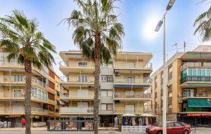 een gebouw met palmbomen ervoor bij 3 Bedroom Awesome Apartment In Santa Pola in Santa Pola