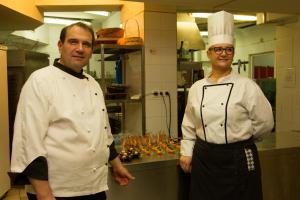 two chefs standing next to each other in a kitchen at Triada Hotel in Sofia