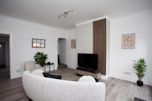 a living room with a couch and a tv at Stylish 2 Bed Home Wifi Smart Tv in Spennymoor