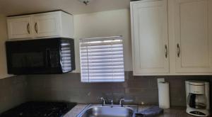 a kitchen with a sink and a microwave at U4 - Cozy 1BR & 1BA Walkup APT in DT PHX with pkg in Phoenix