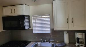 a kitchen with a sink and a microwave at U4 - Cozy 1BR & 1BA Walkup APT in DT PHX with pkg in Phoenix +7 photos