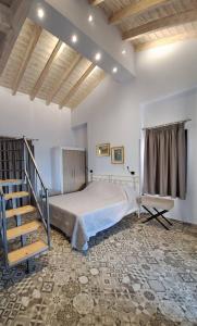 a bedroom with a large bed and a staircase at Villa Don Kostangelo in Nikiana