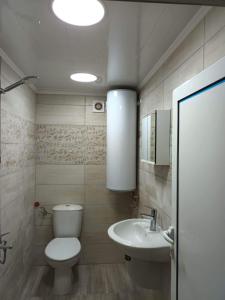 a bathroom with a toilet and a sink at Вила Кичево in Varna City