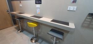 a bathroom with a counter and two stools in a room at Guesthouse@ Bukit Bintang in Kuala Lumpur