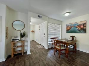a dining room with a table and a mirror at Cabo San Roman entire Condo with patio 5 min from Casino in Lake Charles