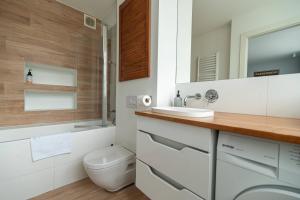 a bathroom with a toilet and a sink and a mirror at Apartment by the Castle - top spot in Szczecin in Szczecin +29 photos