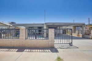 a brick building with a gate in front of it at Updated El Centro Home with Private Patio in El Centro