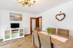a dining room with a table and chairs and a chandelier at Ferienwohnung Murgperle in Gernsbach