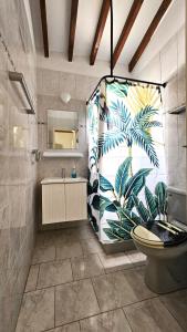a bathroom with a large mural of a plant at Kings Bungalow in Paphos
