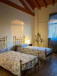 a bedroom with two beds and a window at Locanda Bistrot Zia Nena 