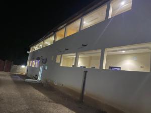 a building with windows on the side of it at night at House Of Lottie in Garoua