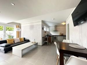 a living room with a couch and a table at Cozy Apartment - Bad Soden - Free Parking in Bad Soden am Taunus