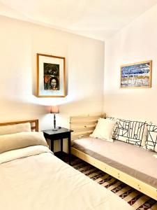 a bedroom with two beds and a table with a lamp at Albaria in Birgi Vecchi