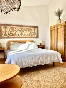 a bedroom with a large bed and a wooden table at Albaria in Birgi Vecchi