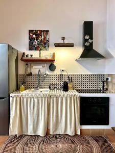 a kitchen with a sink and a stove at Albaria in Birgi Vecchi