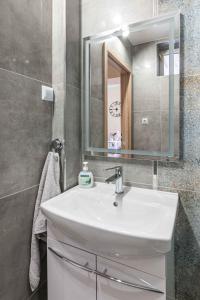 a bathroom with a white sink and a mirror at New apartment - Sunny & Quiet - 45m2 in Oświęcim