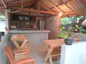 a kitchen with a wooden table and a table and chairs at Saimon Villa in Mirissa