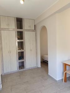 a room with white cabinets and a bed at Nesea 2 in Psérimos