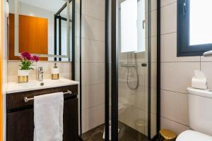 a bathroom with a shower and a toilet and a sink at Melblue in Estreito da Calheta +16 photos