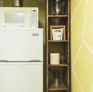 a microwave oven sitting on top of a refrigerator at Cozy Apartment Minutes From Downtown in Rapid City