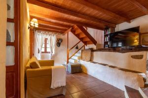 a living room with a couch and a window at Finca Casas Nanitas in Moya +64 photos