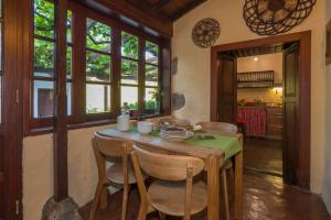 a kitchen with a wooden table and chairs at Finca Casas Nanitas in Moya