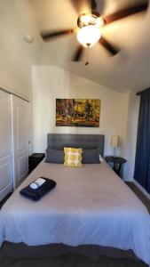 a bedroom with a large bed with a ceiling at U5 - Welcoming 2-Story 2 BR & 2 BA in DT PHX with pkg in Phoenix