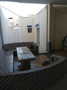una stanza con tavolo al centro di un edificio di Darna a El Haouaria
