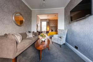 a living room with a couch and a table at The Royal Wells Hotel in Royal Tunbridge Wells