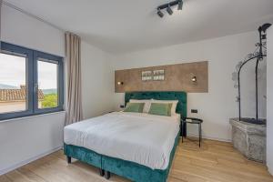 a bedroom with a bed and a large window at Casa Fortunato with Private Pool in Pićan +30 photos